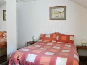 a bedroom with a bed with a colorful comforter at Strathspey in Largs