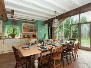 a dining room with a long table and chairs at Rhydleos Mill in Llansilin