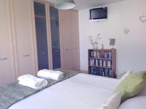 a bedroom with a bed with two towels on it at Sweet Briar in Newquay