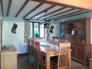 a dining room with a wooden table and chairs at Orchard House in Chipping Campden