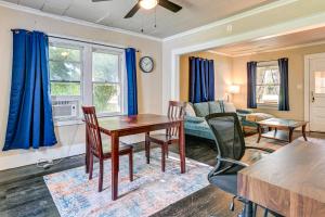 a living room with a table and chairs at 3 Mi to Dtwn Saginaw Cozy Family Home with Yard! in Saginaw