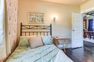 a bedroom with a bed and a table at 3 Mi to Dtwn Saginaw Cozy Family Home with Yard! in Saginaw