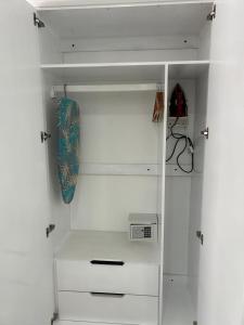 a white closet with a skateboard in it at Agape Suites-Room 2-Ground Floor in Soufrière