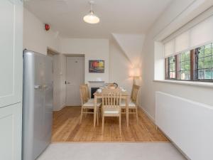 a kitchen and dining room with a table and chairs at Stable Yard Cottage in Selborne