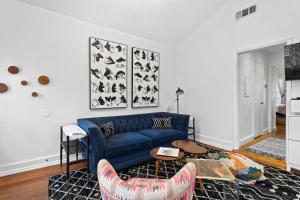 a living room with a blue couch and a table at Modern Midtown-The Carriage House -Free Parking in Atlanta