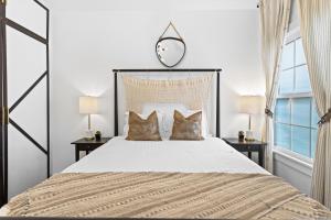 a bedroom with a large bed with two pillows at Modern Midtown-The Carriage House -Free Parking in Atlanta