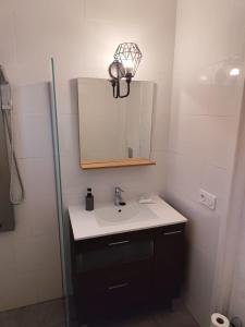 a bathroom with a sink and a mirror at "Terrasse de la Mer 8" Résidence"Sol y Mar" AC-Wifi-BBQ-Piscine-Pkg in Begur
