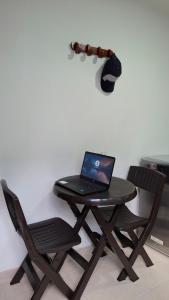 a laptop computer sitting on a picnic table with two chairs at Hostal Doña Eliza in Bogotá