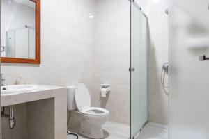 a bathroom with a toilet and a sink and a shower at Blue Oceana Villa in Nusa Dua +9 photos