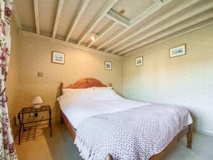 a bedroom with a large bed and a table at Oaklands Farm - Cottage 4 in Broughton