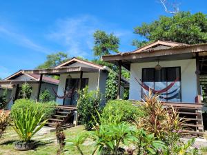 a cottage in the middle of a garden at Bigfin beach resort in Kota Belud