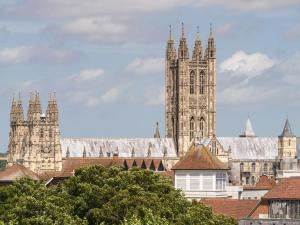 a large building with a clock tower in a city at The Stable in Crundale +2 photos