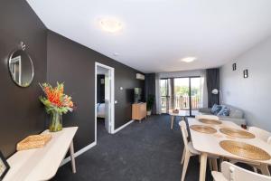 a room with tables and chairs and a living room at Griffin 165 in Kingston 