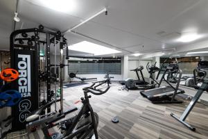 a gym with several exercise bikes in a room at Griffin 165 in Kingston  +7 photos