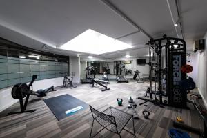 a gym with a lot of exercise equipment in it at Griffin 165 in Kingston 