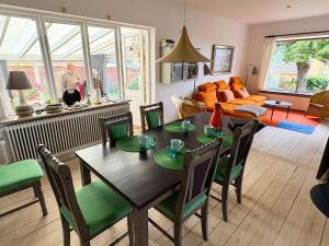 a living room with a table and chairs and a couch at 6 person holiday home in Hasle in Rønne +15 photos