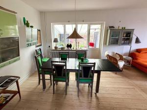 a living room with a dining room table and chairs at 6 person holiday home in Hasle in Rønne
