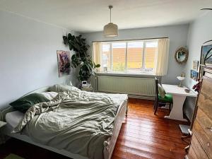 a bedroom with a bed and a desk and a window at 6 person holiday home in Hasle in Rønne