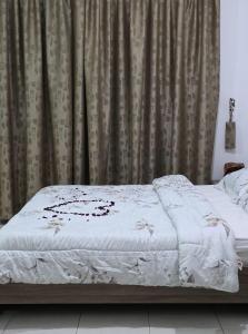 a bed in a bedroom with a curtain at غرف فندقيه - بدع زايد in Bū Rays