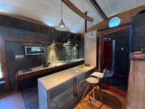 a kitchen with a counter and a sink and a counter at Loft acogedor en el campo in Putaendo +8 photos