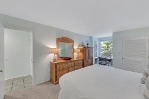 a bedroom with a bed and a dresser and a mirror at PW1357: 1357 Pelican Watch in Seabrook Island +28 photos