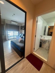 a bedroom with a mirror and a bed and a sink at ห้องพัก แบบ Studio ติดเซ็นทรัลเวสเกต in Ban Bang Krabu +16 photos