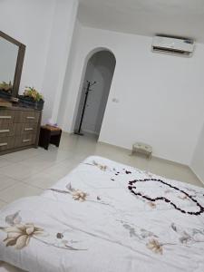 a bedroom with a bed with flowers on it at غرف فندقيه - بدع زايد in Bū Rays