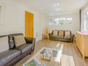a living room with a couch and a table at Keepers Wood - W43109 in Bradworthy