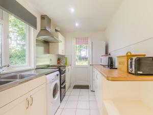 a kitchen with a sink and a dishwasher at Keepers Wood - W43109 in Bradworthy