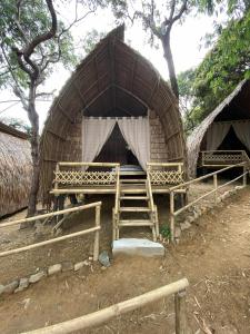 a small hut with a staircase in front of it at MORE Beach in El Nido