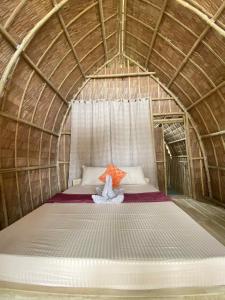 a room with a bed in a yurt at MORE Beach in El Nido