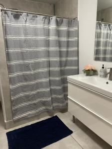 a bathroom with a shower curtain and a sink at Family Beach House with an Amazing Ocean View in Naguabo