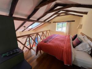 a bedroom with a bed in a room with beams at Melissa Wasi in Pisac