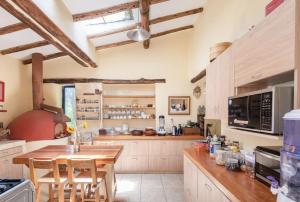 a large kitchen with a wooden table and chairs at Melissa Wasi in Pisac +47 photos