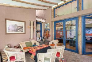a living room with a table and chairs at Melissa Wasi in Pisac