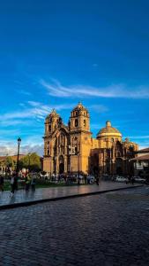 a large stone building with a blue sky in the background at ECOTERRA-SAN FRANCISCO Cusco in Cusco