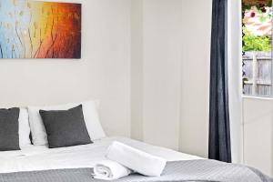 a bedroom with a bed with towels on it at Relaxed Private Double Room in Carramar - Close to Station - Shared Bathroom in Villawood