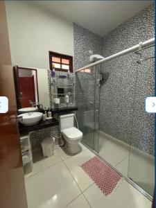 a bathroom with a shower and a toilet and a sink at casa sol e mar 01 in Paripueira +23 photos