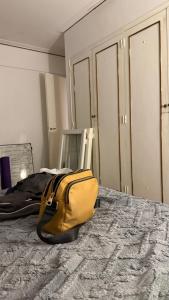 a yellow bag sitting on top of a bed at A pasos del Alto Vintge in Rosario