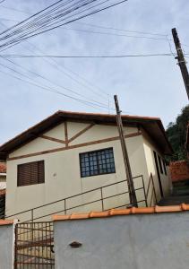 a house with a fence in front of it at House - Cantinho de Jacaré in Jacarèzinho