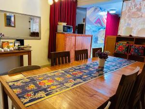 a dining room table with a rug on top of it at ECOTERRA-SAN FRANCISCO Cusco in Cusco