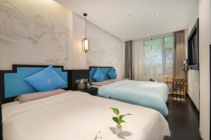 Ένα ή περισσότερα κρεβάτια σε δωμάτιο στο Gongxili - Chujian Hotel