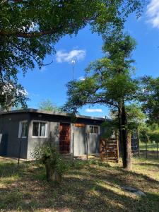 a small house with a tree in front of it at Caminito in Villa Anizacate