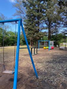 a swing set in a park with a playground at Caminito in Villa Anizacate +2 photos