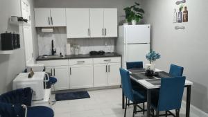 une cuisine avec une table, des chaises et un réfrigérateur dans l'établissement Blue Dream Sunrise - Your journey, our passion, à Lakeland