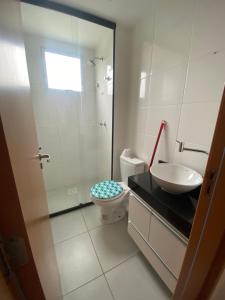 Un baño con ducha, inodoro y lavabo. en Residencial Dalí, en Duque de Caxias