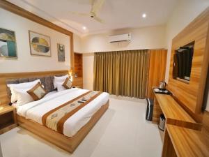 a bedroom with a large bed in a room at Hotel Sunshine At Delhi Airport in Dwarka, New Delhi