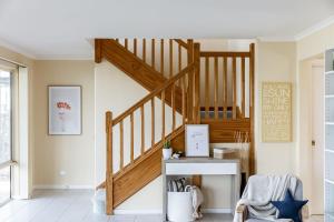 a staircase in a living room with a desk at Sunnys Beachhouse - 70 Hargreaves Rd, Middleton in Middleton