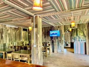 a dining room with tables and a tv on the ceiling at Sky View hostel in Sapa