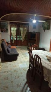 a living room with a bed and a couch at Maison d'hôte Trésor in Sainte-Anne
